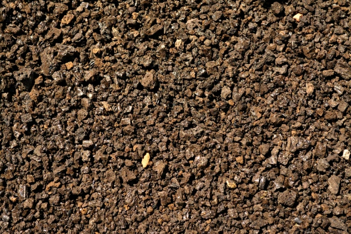 a close up of a dirt surface with small rocks